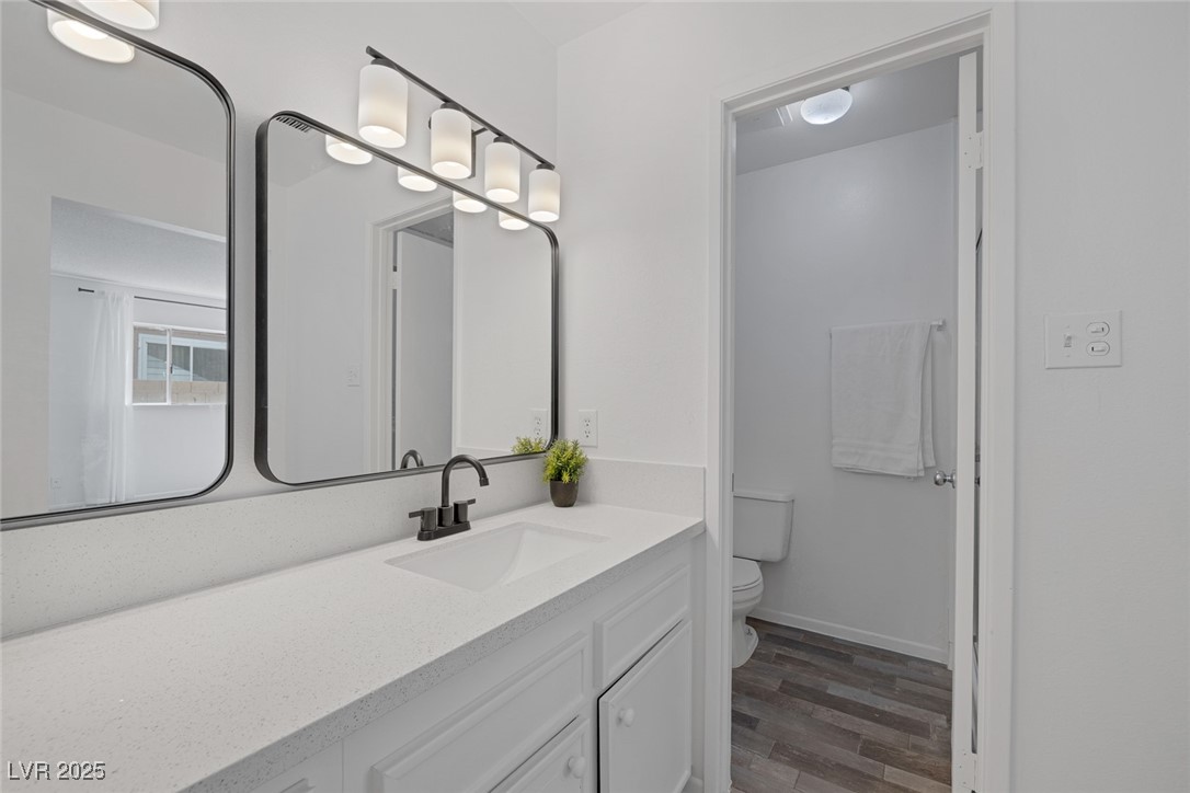 720 Sam Jonas Drive Las Vegas, NV 89145 - Photo 21 of 34 Bathroom with baseboards, wood finished floors, va