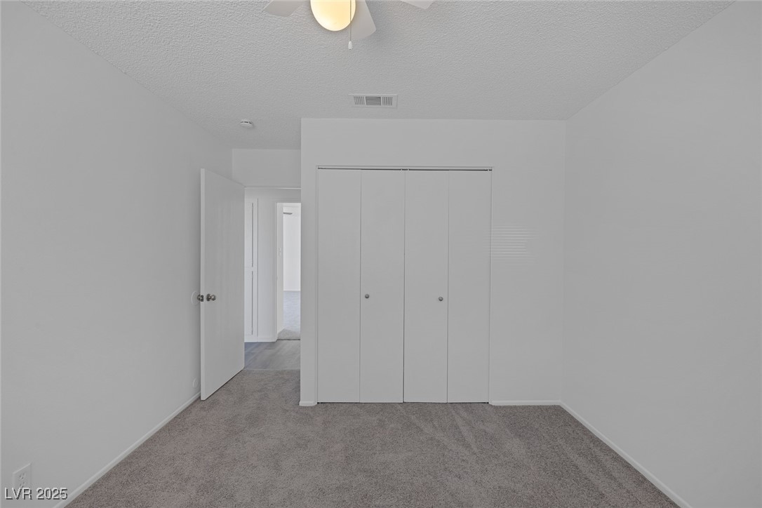 720 Sam Jonas Drive Las Vegas, NV 89145 - Photo 26 of 34 Unfurnished bedroom with a closet, a textured ceil