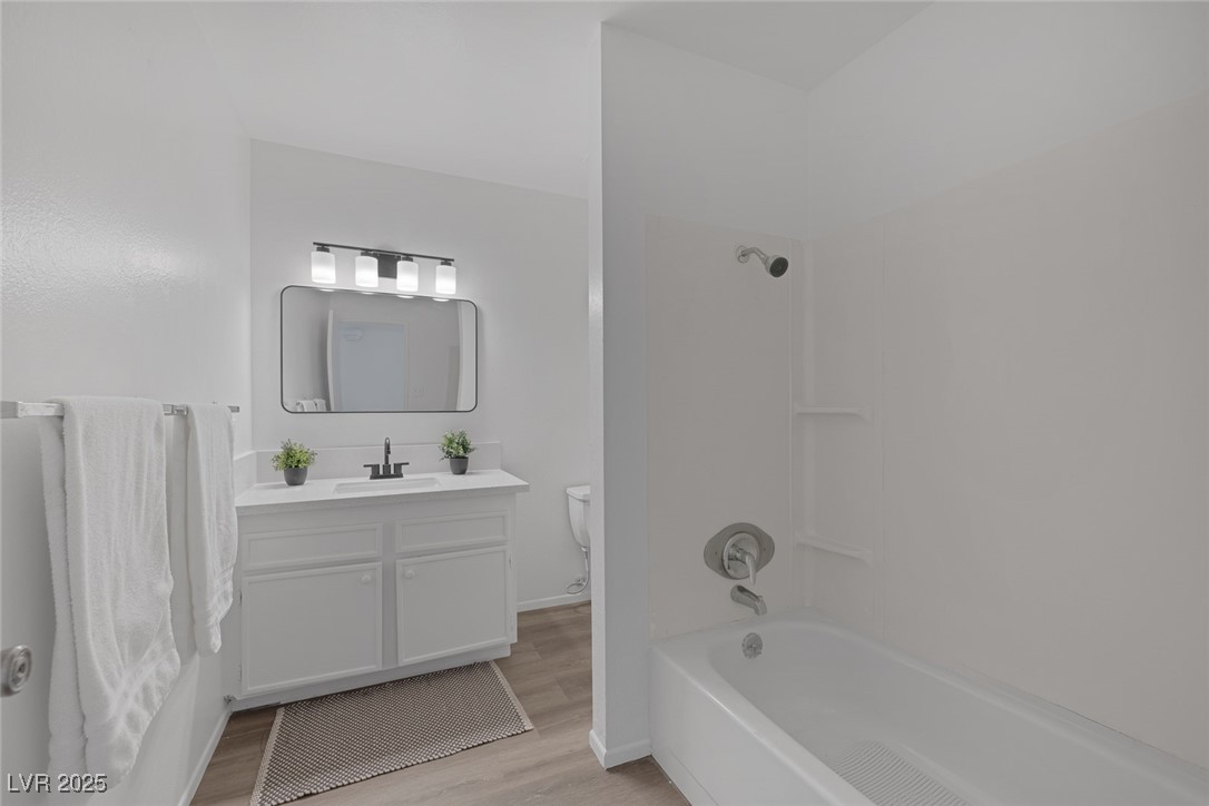 720 Sam Jonas Drive Las Vegas, NV 89145 - Photo 27 of 34 Bathroom with wood finished floors, toilet, vanity