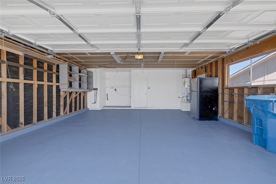 720 Sam Jonas Drive Las Vegas, NV 89145 - Photo 28 of 34 Garage with freestanding refrigerator, strapped wa