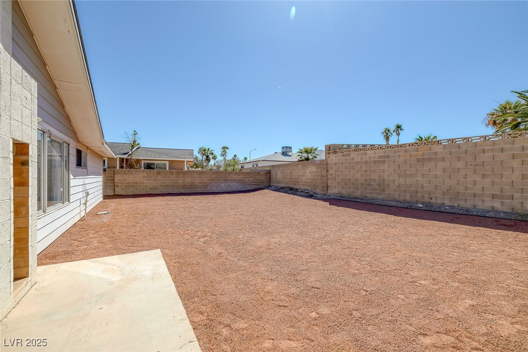 720 Sam Jonas Drive Las Vegas, NV 89145 - Photo 29 of 34 View of yard featuring a patio area and a fenced b