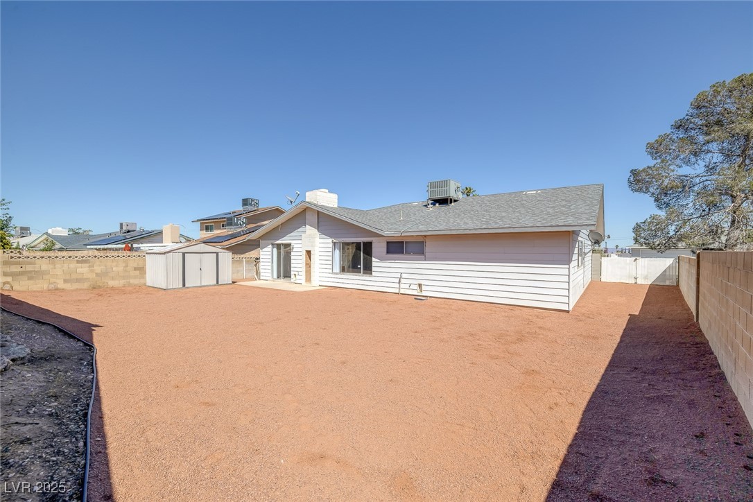 720 Sam Jonas Drive Las Vegas, NV 89145 - Photo 32 of 34 Rear view of house featuring a storage shed, an ou