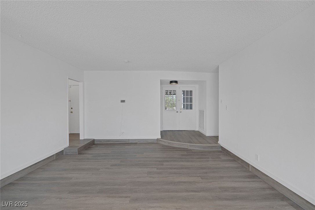 720 Sam Jonas Drive Las Vegas, NV 89145 - Photo 4 of 34 Unfurnished room with visible vents, wood finished