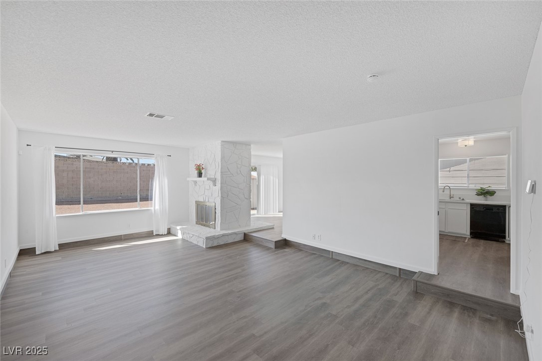 720 Sam Jonas Drive Las Vegas, NV 89145 - Photo 6 of 34 Unfurnished living room with wood finished floors,