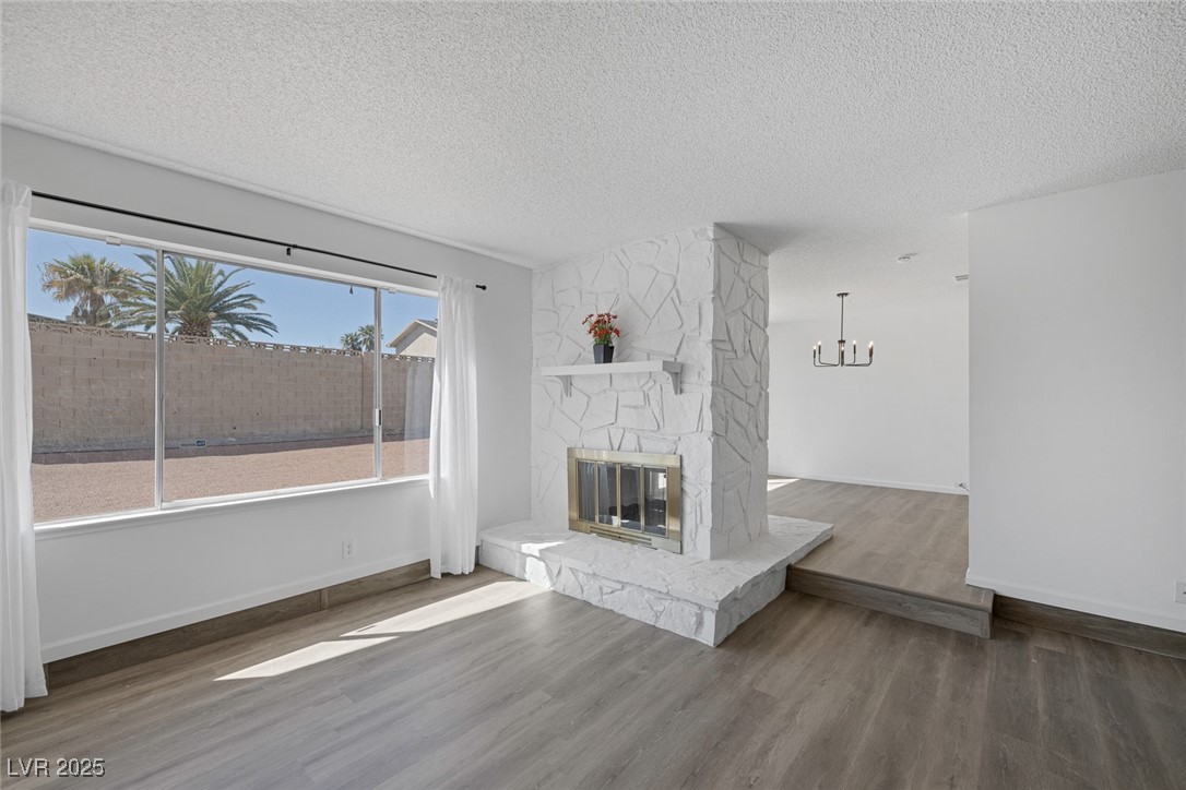 720 Sam Jonas Drive Las Vegas, NV 89145 - Photo 8 of 34 Unfurnished living room featuring baseboards, a fi