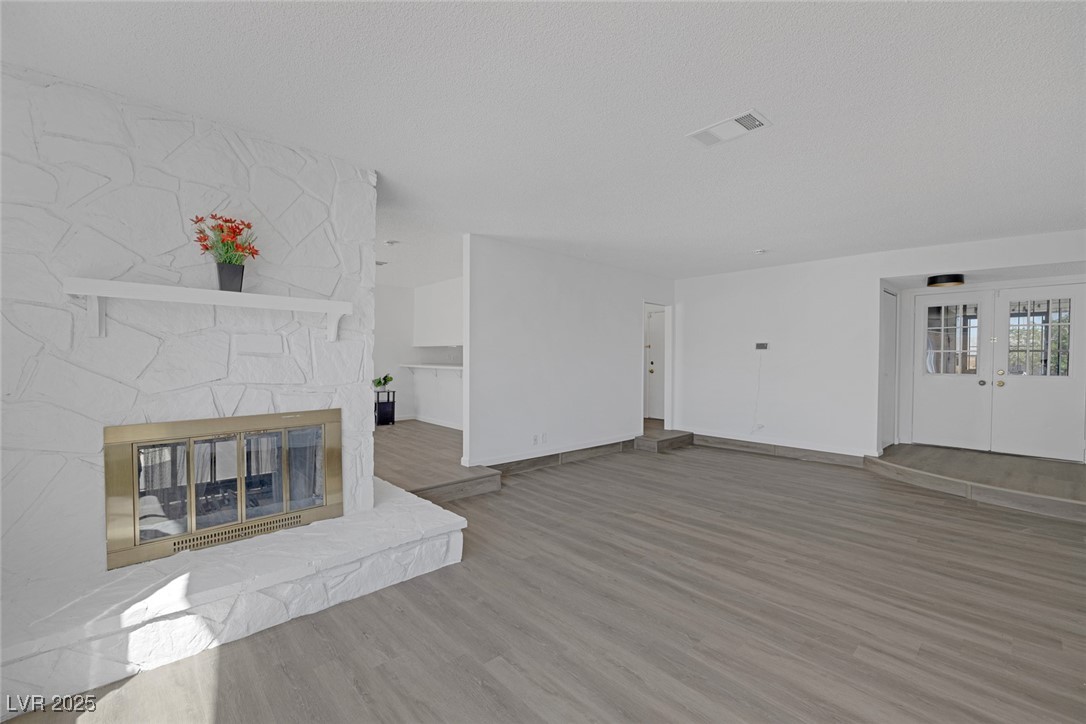 720 Sam Jonas Drive Las Vegas, NV 89145 - Photo 10 of 34 Unfurnished living room with baseboards, wood fini