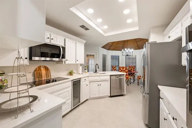 a kitchen that has a lot of cabinets and appliances
