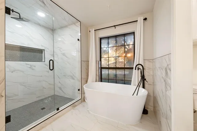 a bathroom with a bathtub and a shower
