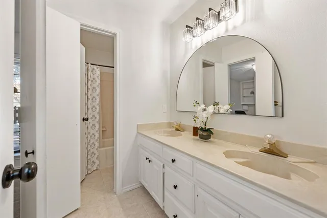 a bathroom with a double vanity sink and a mirror