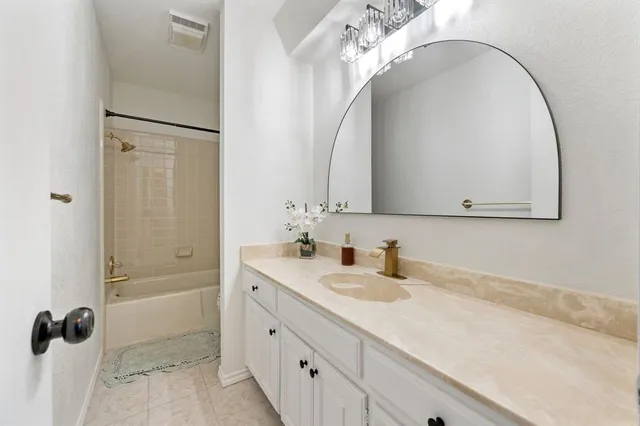 a bathroom with a double vanity sink mirror and shower