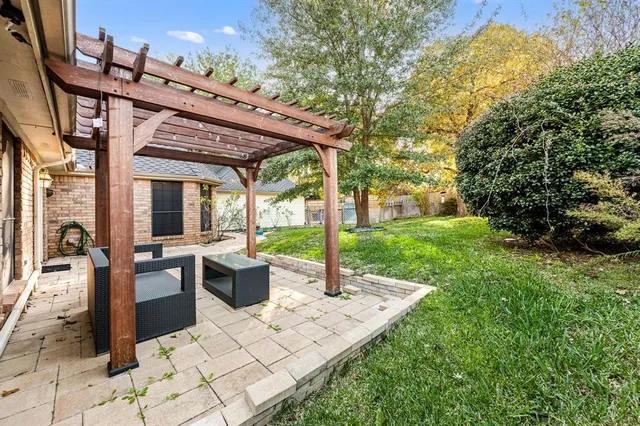 a view of a patio with chairs and potted plants
