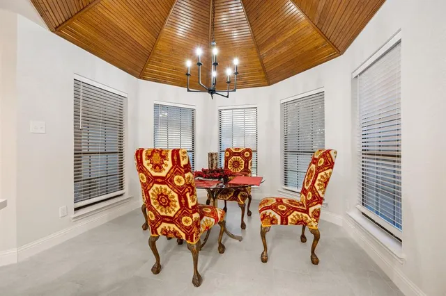 a view of a dining room with furniture and chandelier