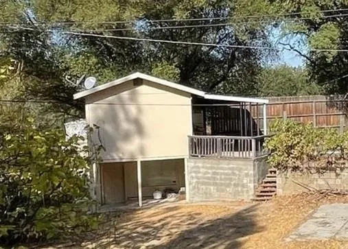 a view of a livingroom with an empty space and a window