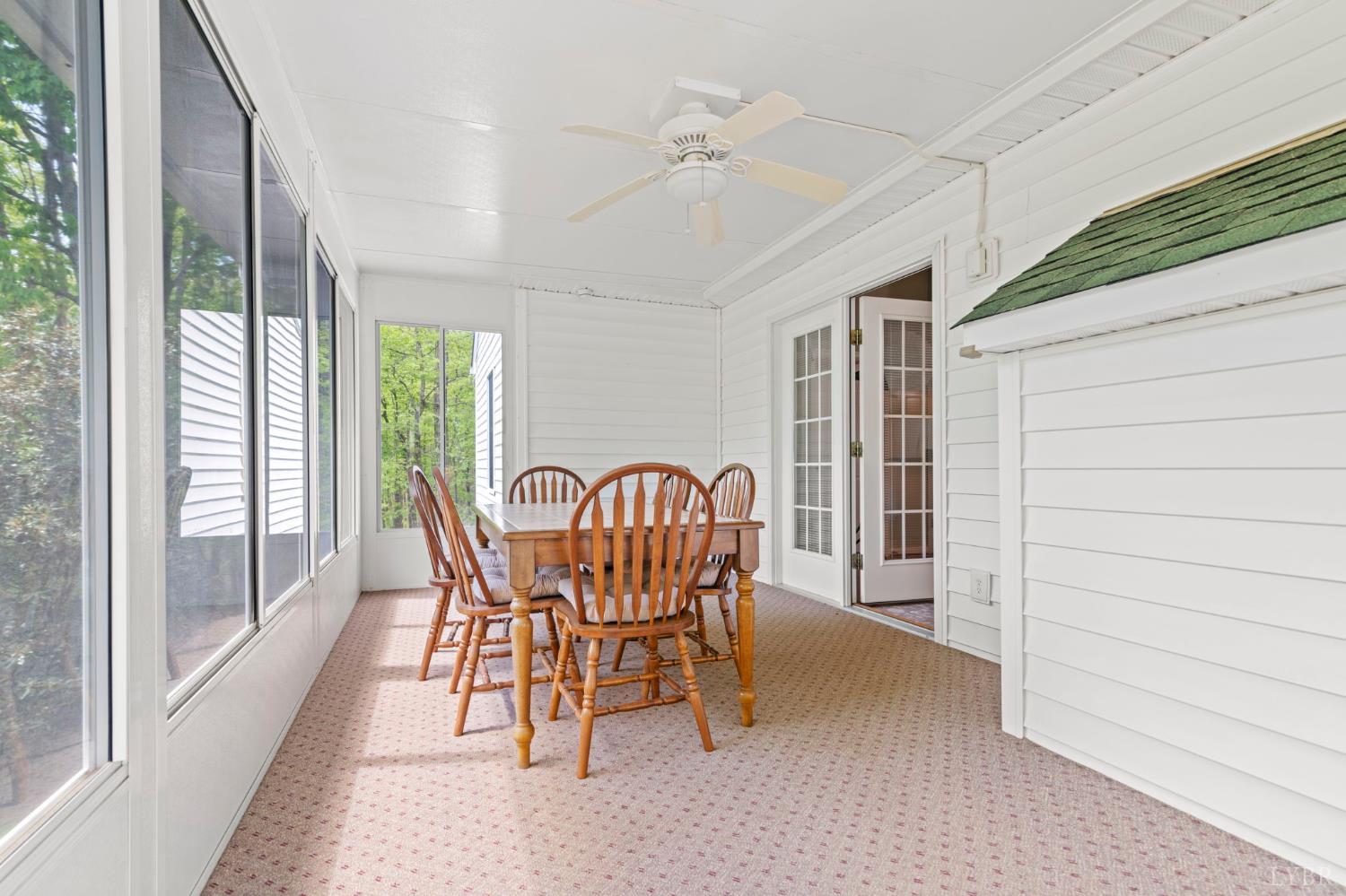 298 Braxton Ridge Road Amherst, VA 24521 - Photo 38 of 65 a dining room with furniture a chandelier and wooden floor