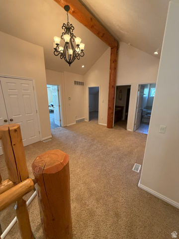 4458 East Glencoe Road Preston, ID 83263 - Photo 24 of 46 Vaulted ceiling with exposed wood beams, wrought iron chandelier, recessed lighting, and neutral carpeting