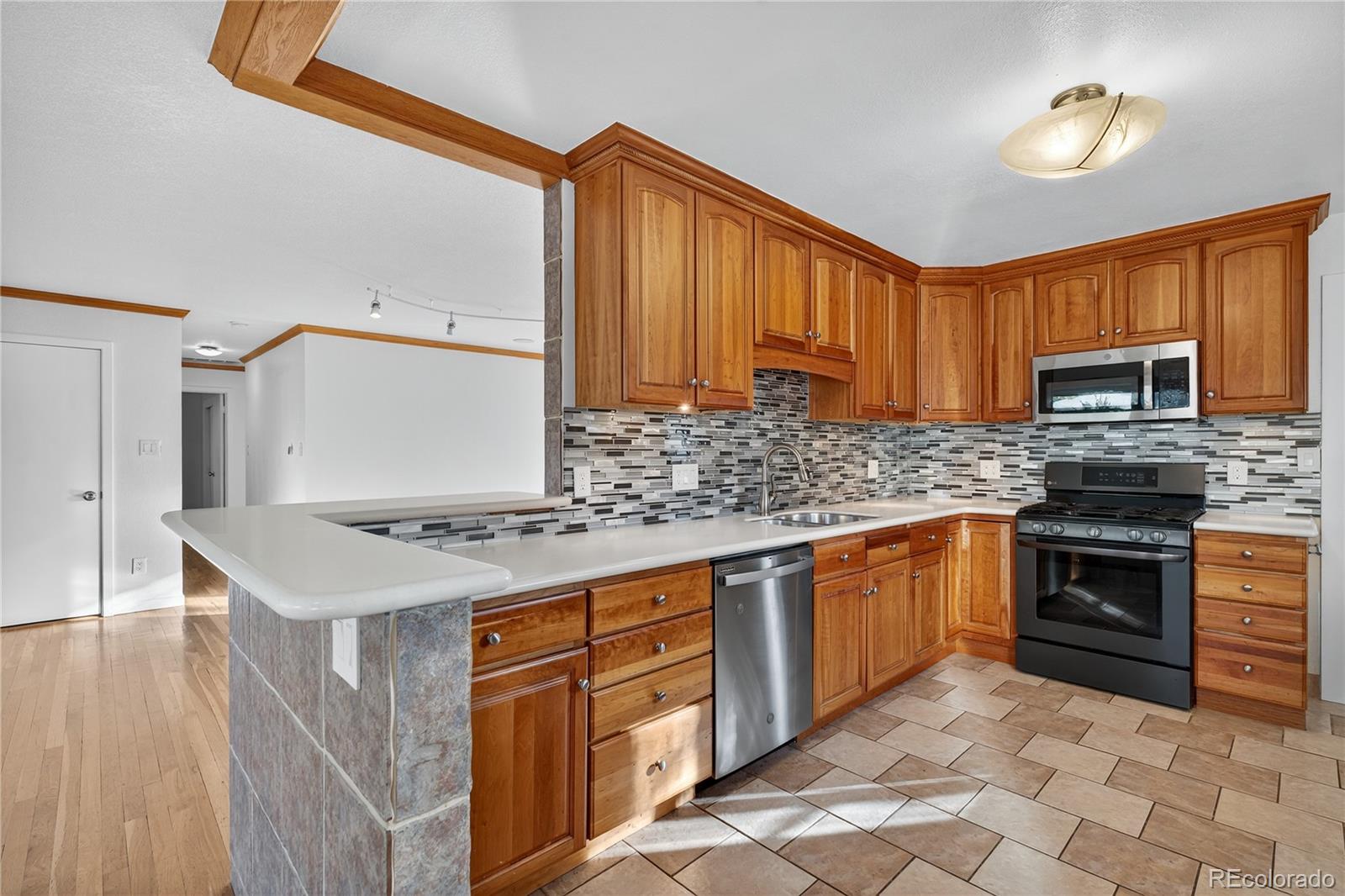 450 South 40th Street Boulder, CO 80305 - Photo 12 of 36 a kitchen with stainless steel appliances granite countertop a stove a sink dishwasher and a microwave oven with cabinets