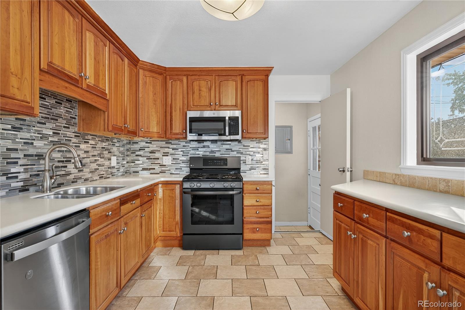 450 South 40th Street Boulder, CO 80305 - Photo 14 of 36 a kitchen with stainless steel appliances granite countertop a sink stove and refrigerator