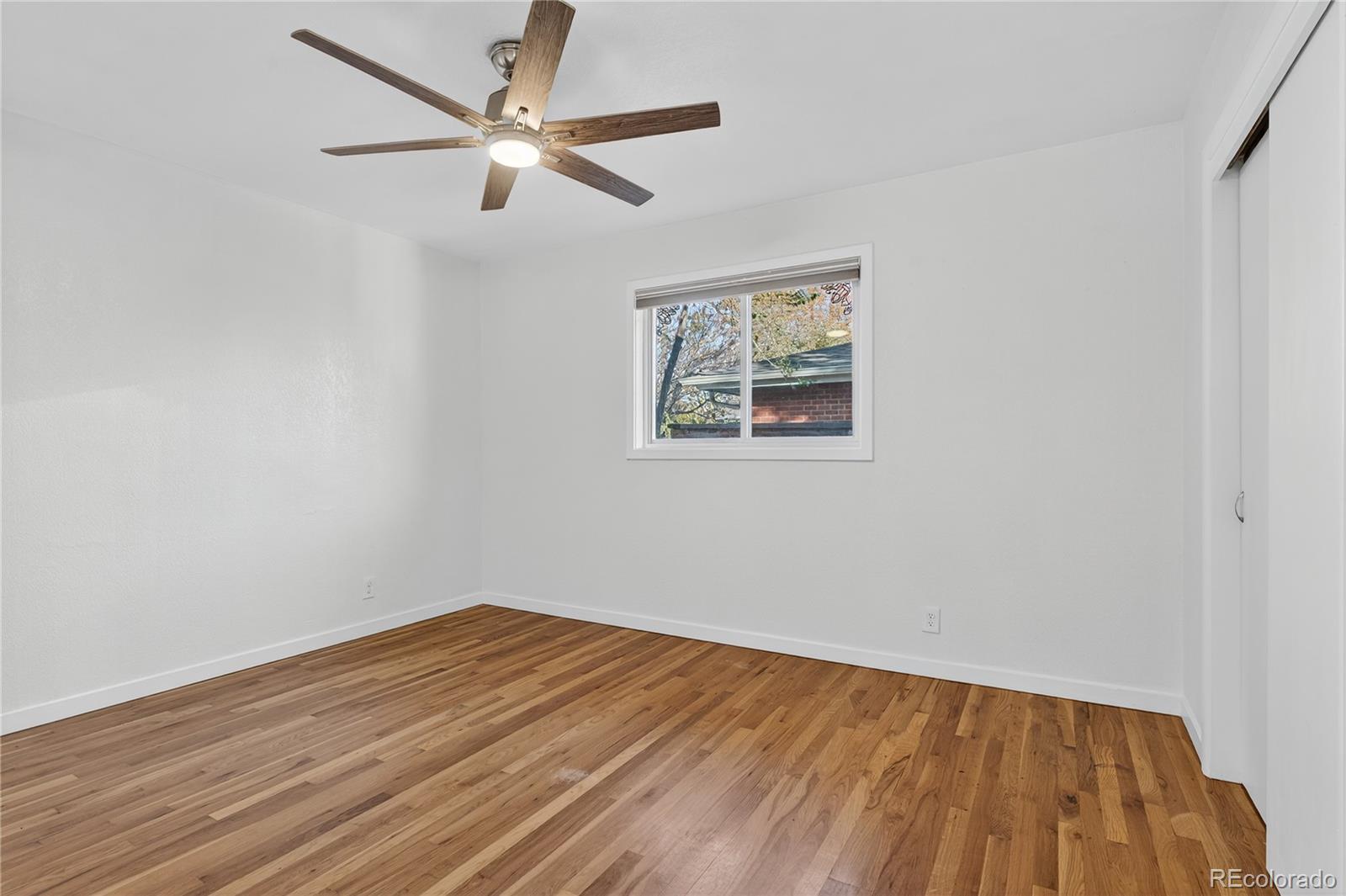 450 South 40th Street Boulder, CO 80305 - Photo 16 of 36 a view of an empty room with wooden floor and a ceiling fan