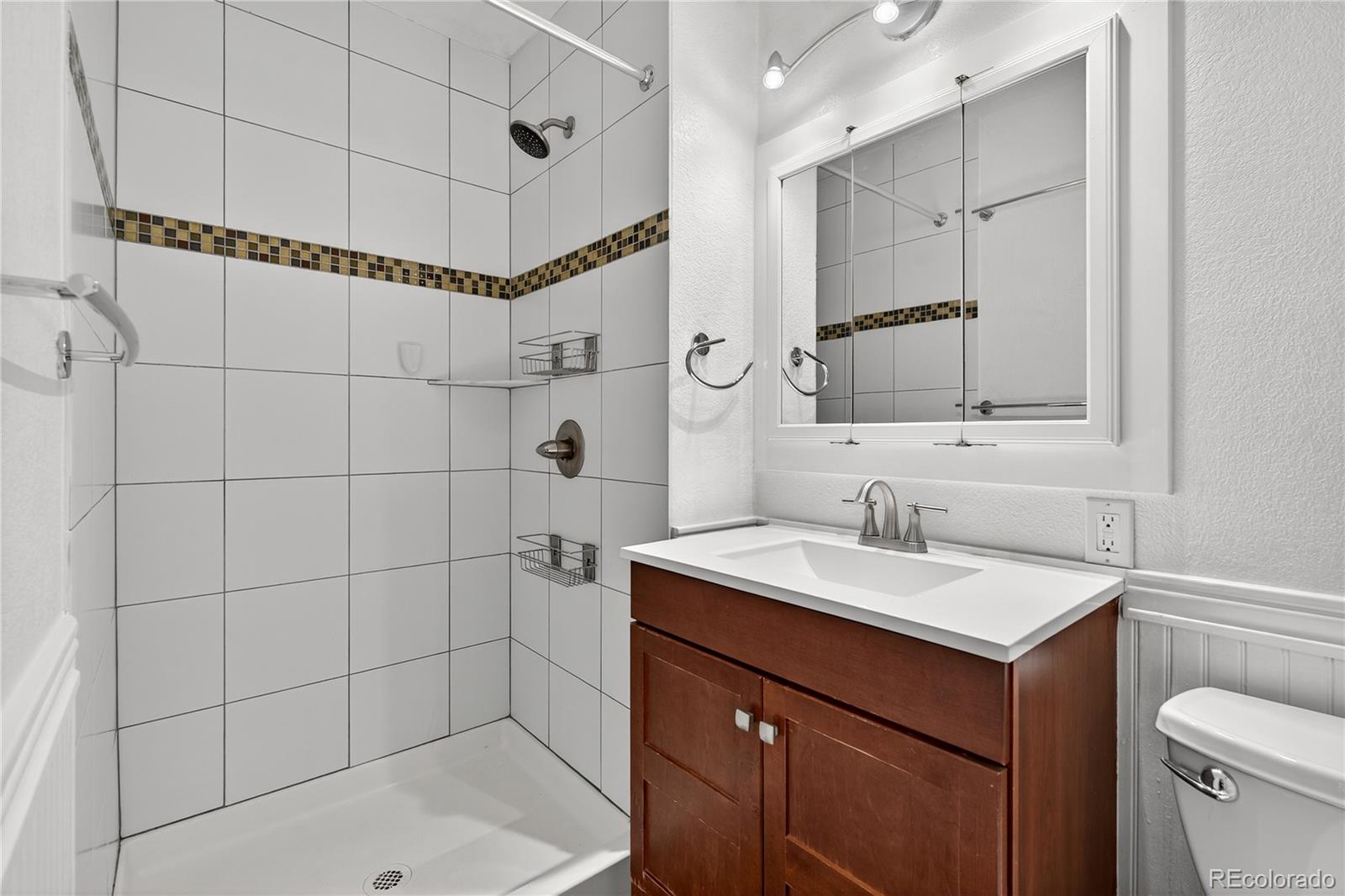 450 South 40th Street Boulder, CO 80305 - Photo 18 of 36 a bathroom with a sink shower vanity and a mirror