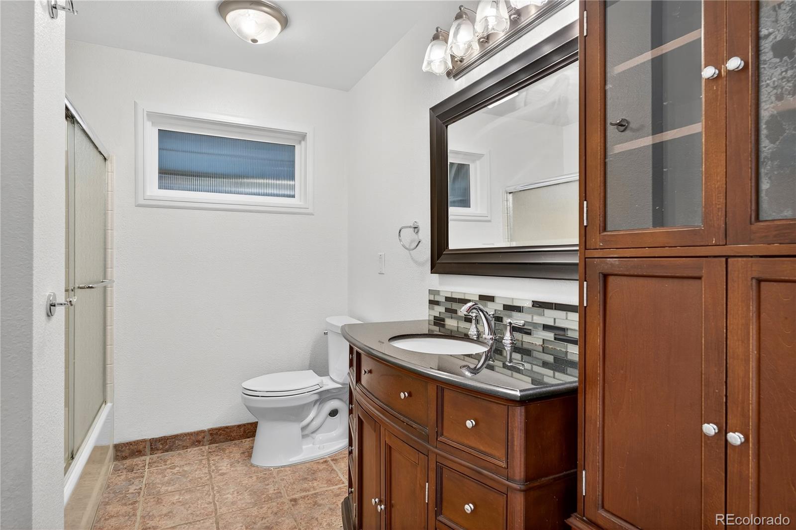 450 South 40th Street Boulder, CO 80305 - Photo 20 of 36 a bathroom with a toilet sink and mirror