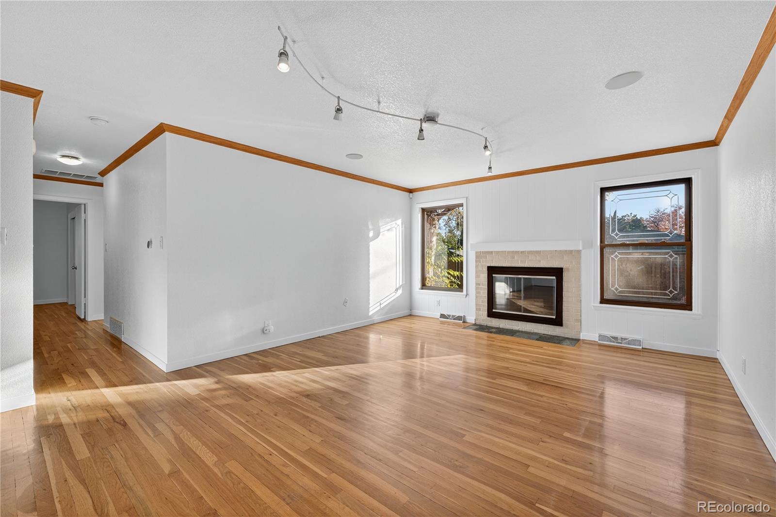450 South 40th Street Boulder, CO 80305 - Photo 7 of 36 a view of empty room with wooden floor and fireplace