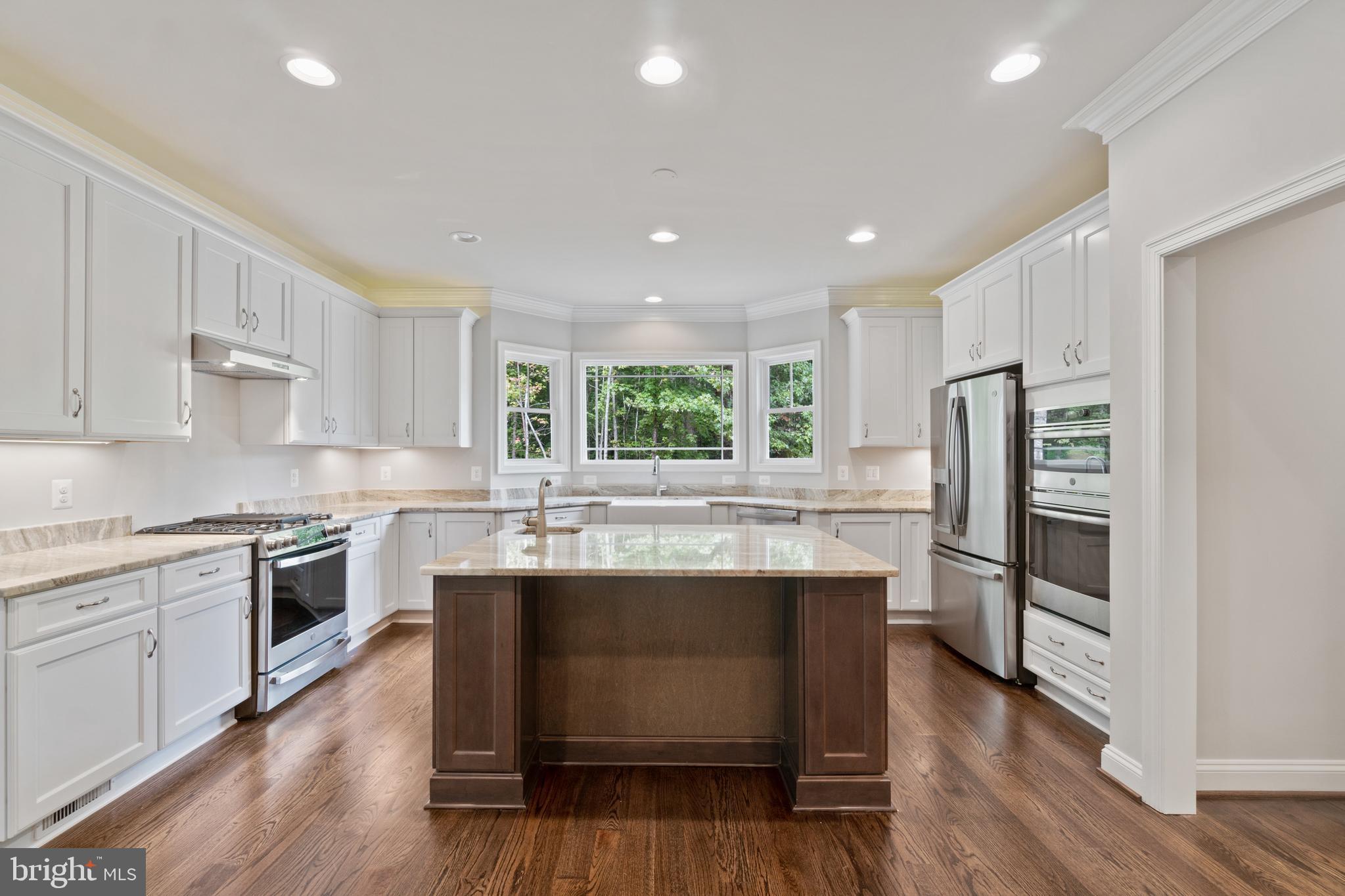 13741 Orlando Road Nokesville, VA 20181 - Photo 15 of 41 a kitchen with kitchen island granite countertop a stove cabinets and wooden floor
