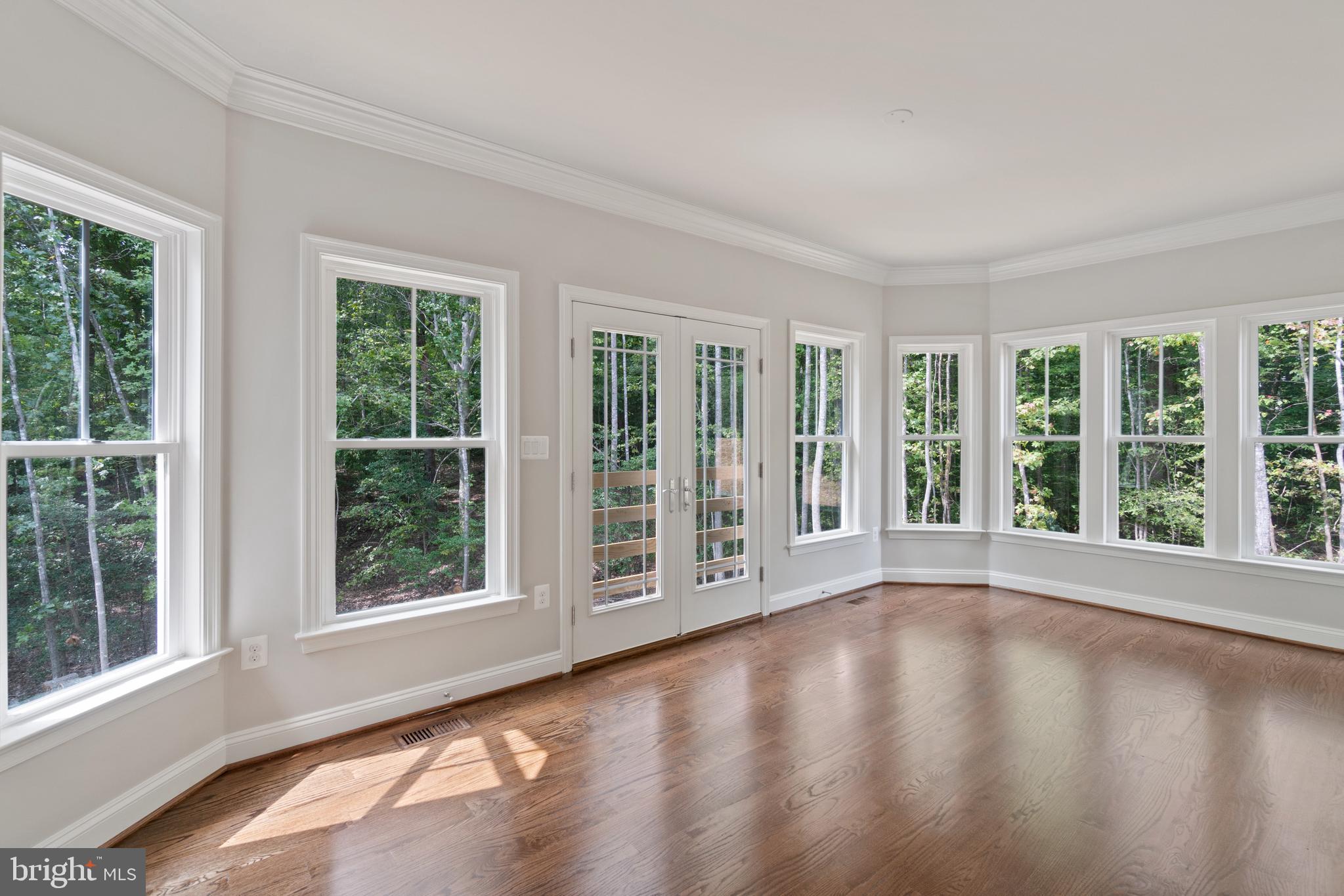 13741 Orlando Road Nokesville, VA 20181 - Photo 20 of 41 a view of an empty room with wooden floor and windows