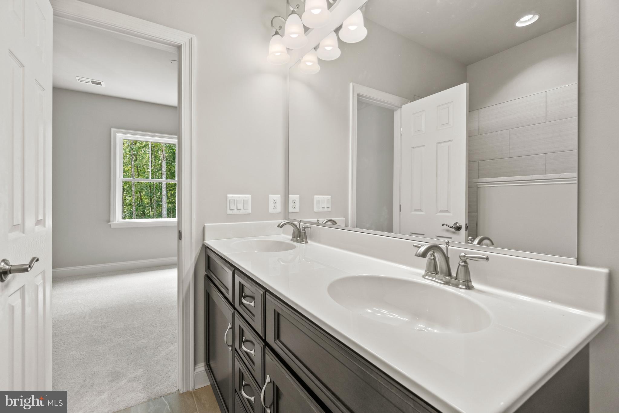 13741 Orlando Road Nokesville, VA 20181 - Photo 29 of 41 a bathroom with a sink double vanity and a mirror