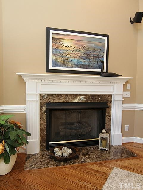 11618 John Allen Road Raleigh, NC 27614 - Photo 5 of 25 Beautiful gas log fireplace surrounded by gorgeous granite, the white mantle makes this fireplace pop! It is a focal point of the Living room, and its great for those chilly nights to kick back and enjoy settling in and keeping warm. Fireplace