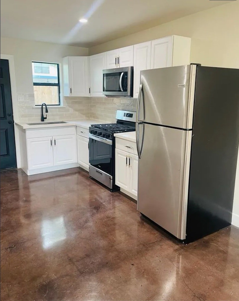 618 East 40th Street, Unit 5 Houston, TX 77022 - Photo 5 of 16 a kitchen with a refrigerator sink and stove