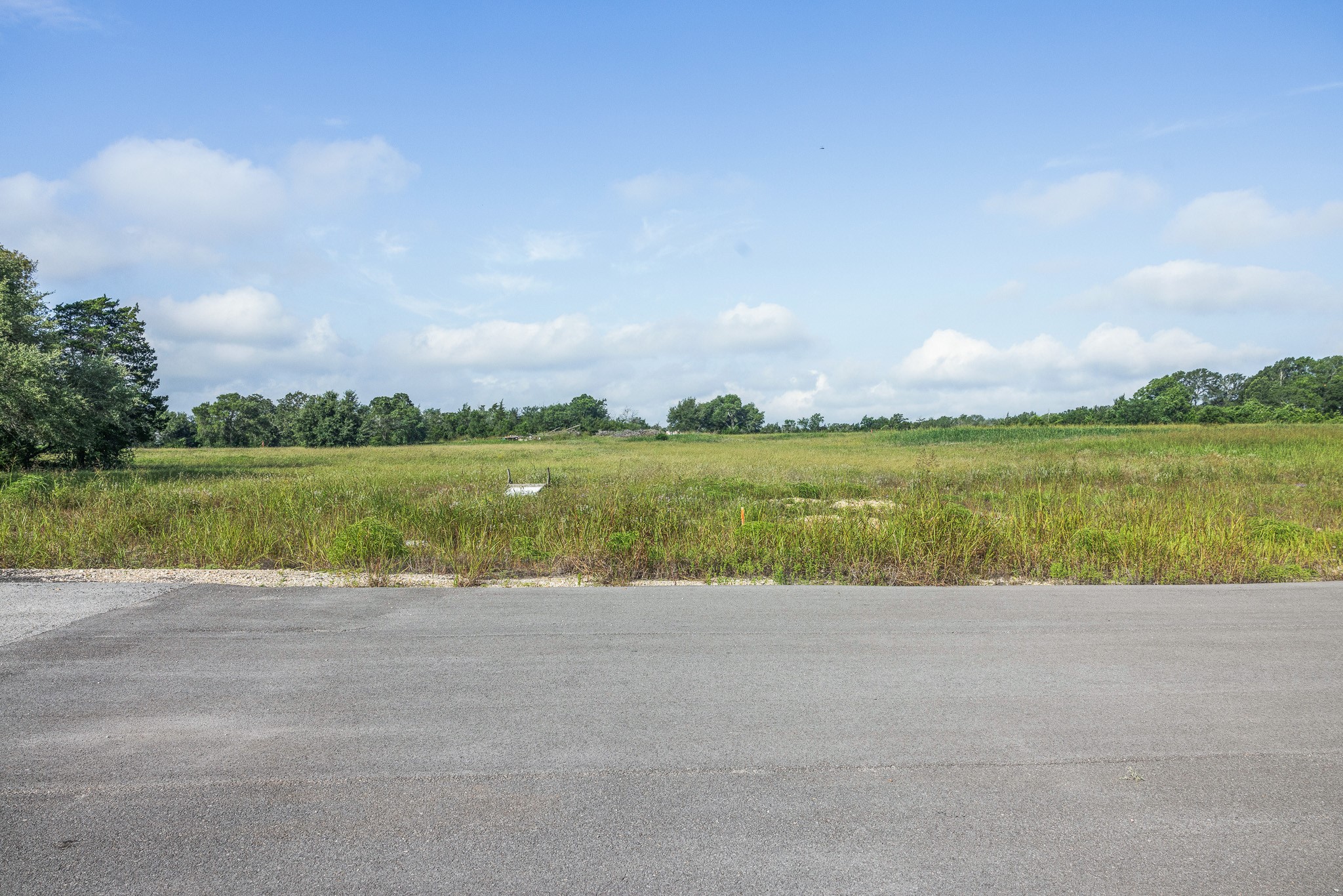 109 Compound Lane Round Top, TX 78954 - Photo 17 of 20 a view of a lake with houses in the background