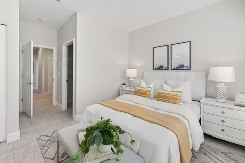 a bedroom with a bed and a lamp