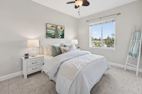 a bedroom with a bed and a window