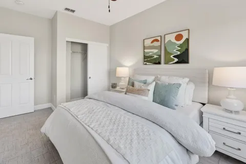 a bed room with a bed and a painting on the wall