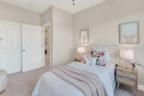 a bedroom with a bed and a mirror