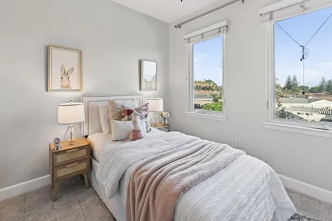 a bedroom with bed and a window