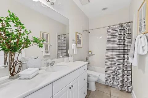 a bathroom with a granite countertop sink a toilet and shower