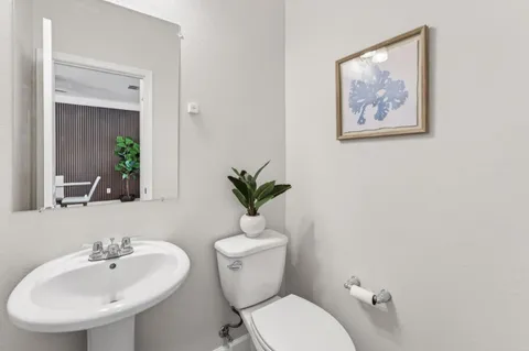 a bathroom with a toilet a sink and a mirror