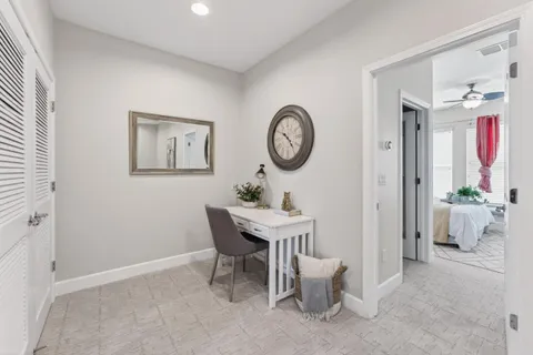 a view of a room that has a table and a chair in it