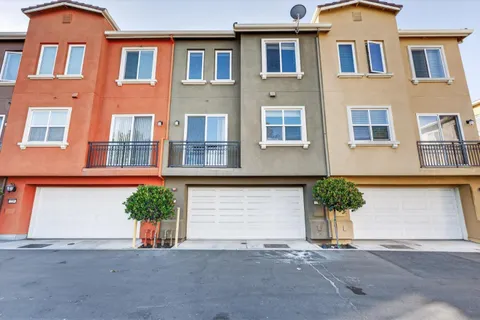 a front view of a house with a yard and a garage