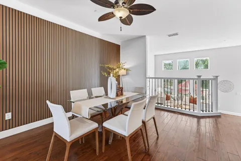 a view of a dining room with furniture and wooden floor