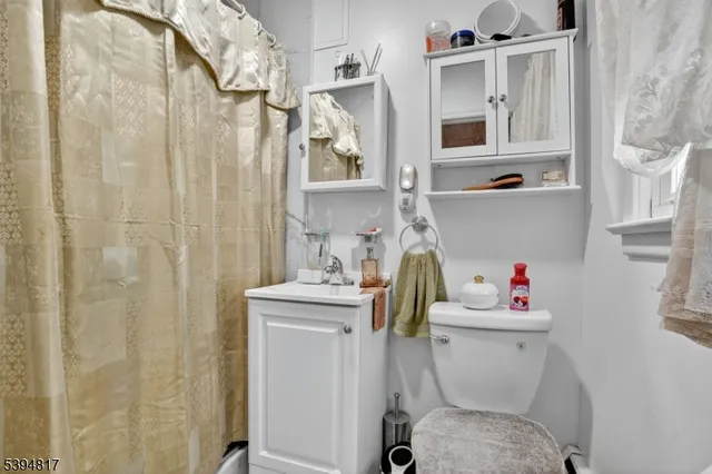 a white toilet sitting next to a bathroom sink