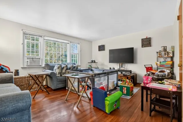 a view of a livingroom with workspace and a window