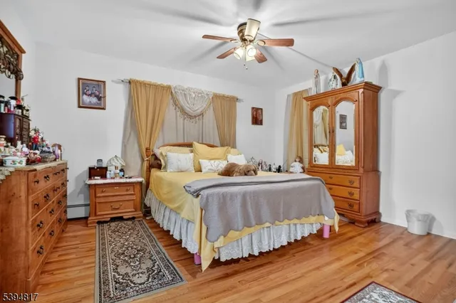 a bedroom with bed and wooden floor