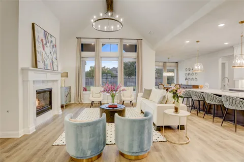 a kitchen with stainless steel appliances granite countertop a kitchen island a stove a table and chairs