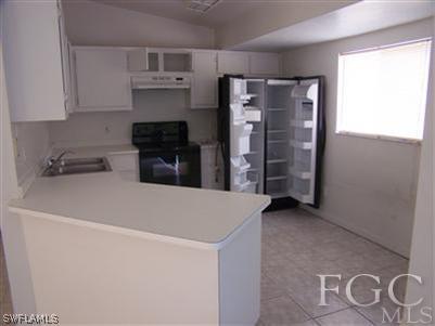 8321 Wren Road Fort Myers, FL 33967 - Photo 8 of 10 a kitchen with stainless steel appliances a refrigerator and a stove