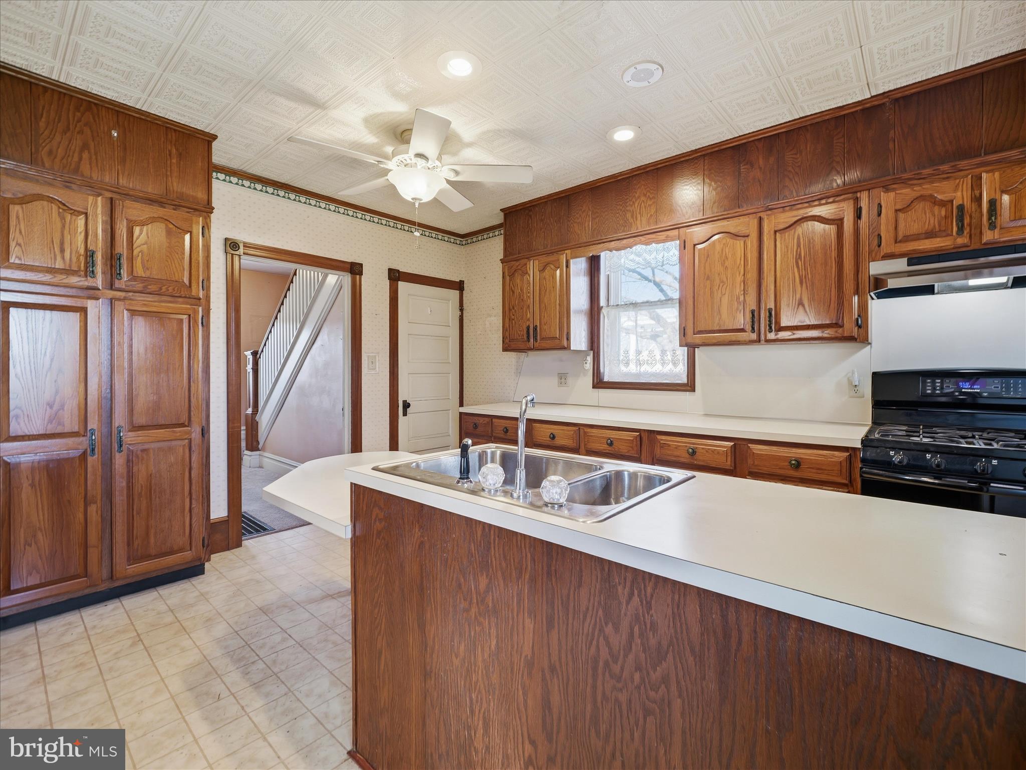 231 Fairview Avenue Waynesboro, PA 17268 - Photo 19 of 45 a kitchen with kitchen island granite countertop a sink stainless steel appliances cabinets and a counter top space
