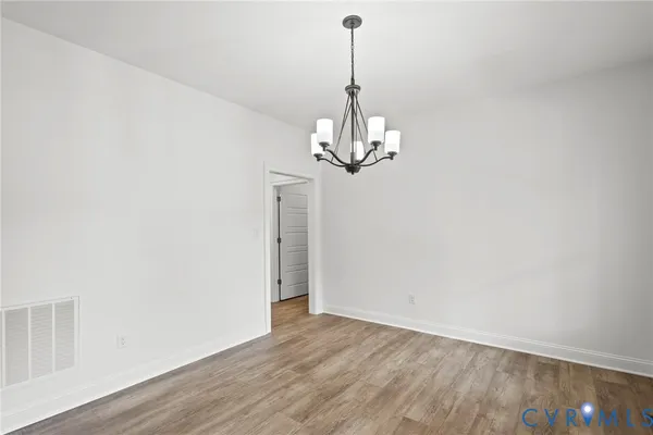 a view of a chandelier in hallway with a chandelier