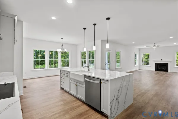 a large kitchen with kitchen island a sink appliances and a large window