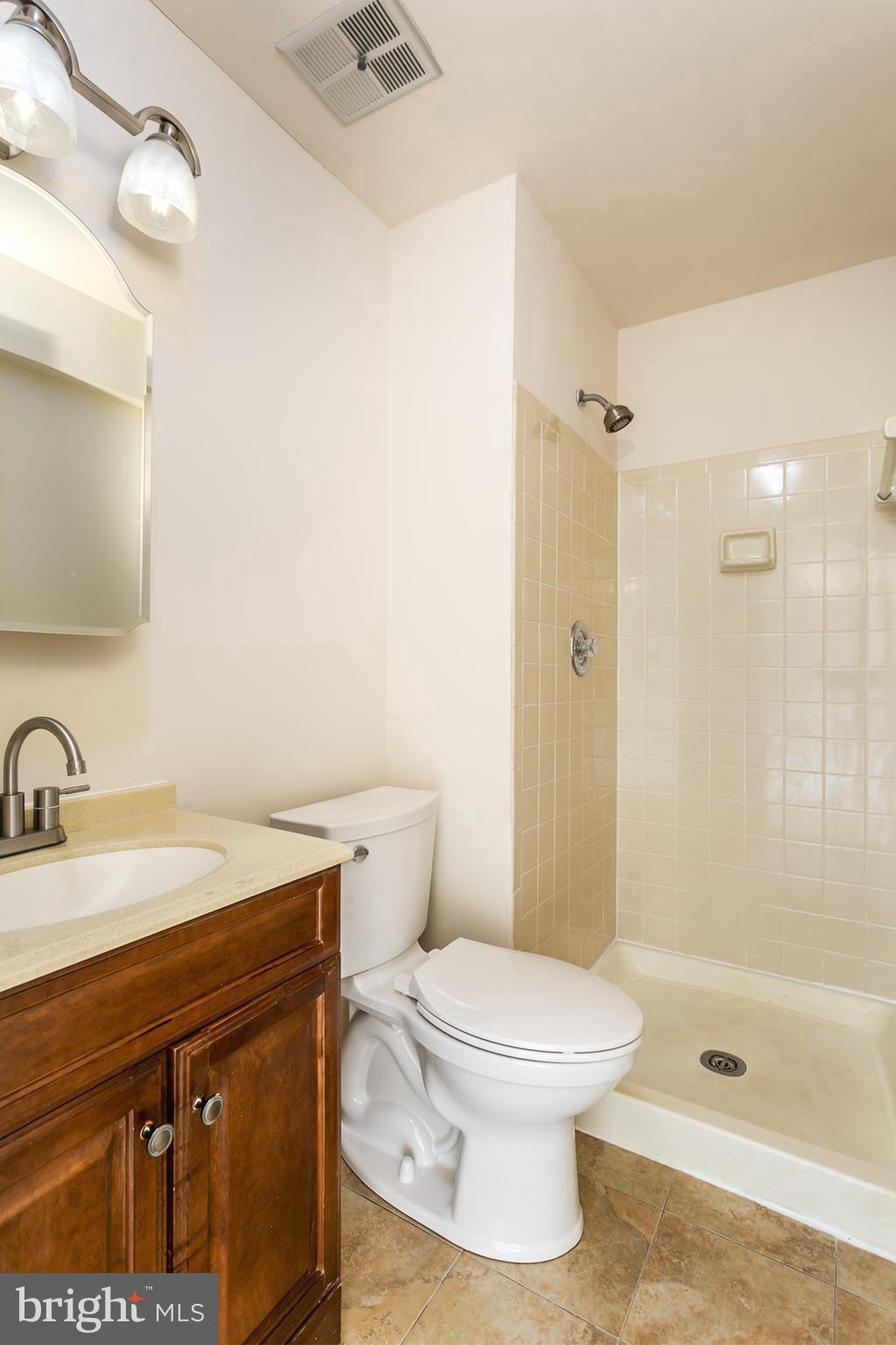 33 Kinsman View Circle Silver Spring, MD 20901 - Photo 20 of 26 a bathroom with a sink a toilet and shower